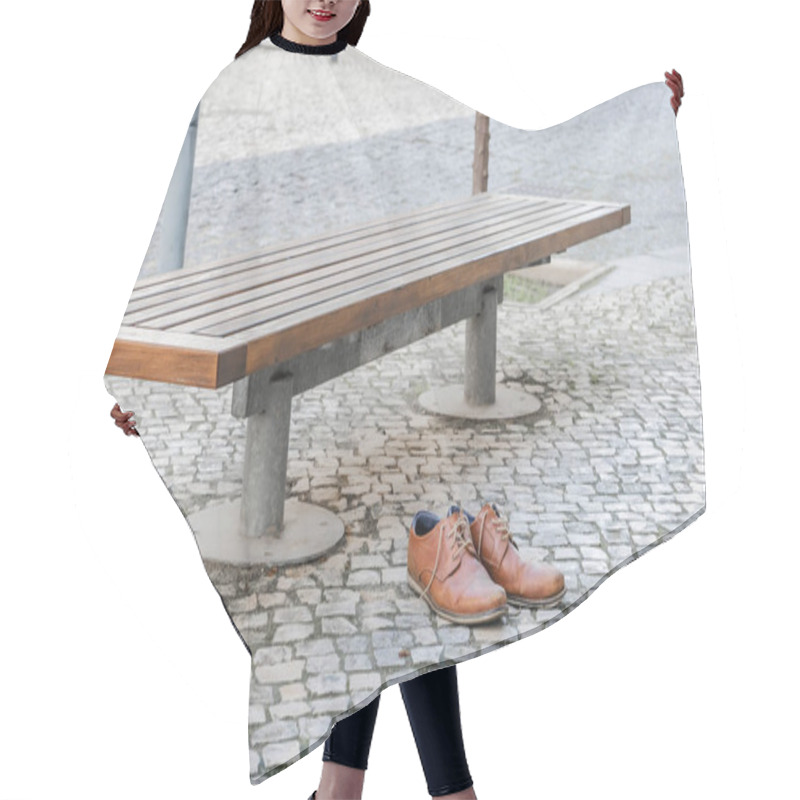 Personality  Brown Leather Shoes On A Cobblestone Pavement Next To A Bench In An Urban Setting. Hair Cutting Cape