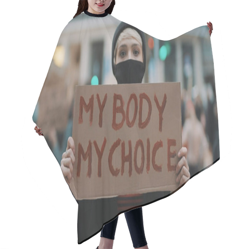 Personality  Woman Holding A Sign My Body, My Choice. Protest Against Tightening Of The Abortion Law . Nationwide Womens Strike. Wearing Protective Face Mask Against COVID-19 Coronavirus. Hair Cutting Cape