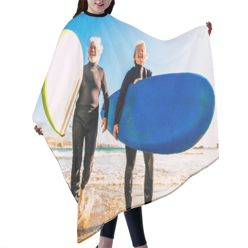 Personality  Couple Of Seniors At The Beach With Black Wetsuits Holding A Surftables Ready To Go Surfing A The Beach - Active Mature And Retired People Doing Happy Activity Together In Their Vacations Or Free Time  Hair Cutting Cape