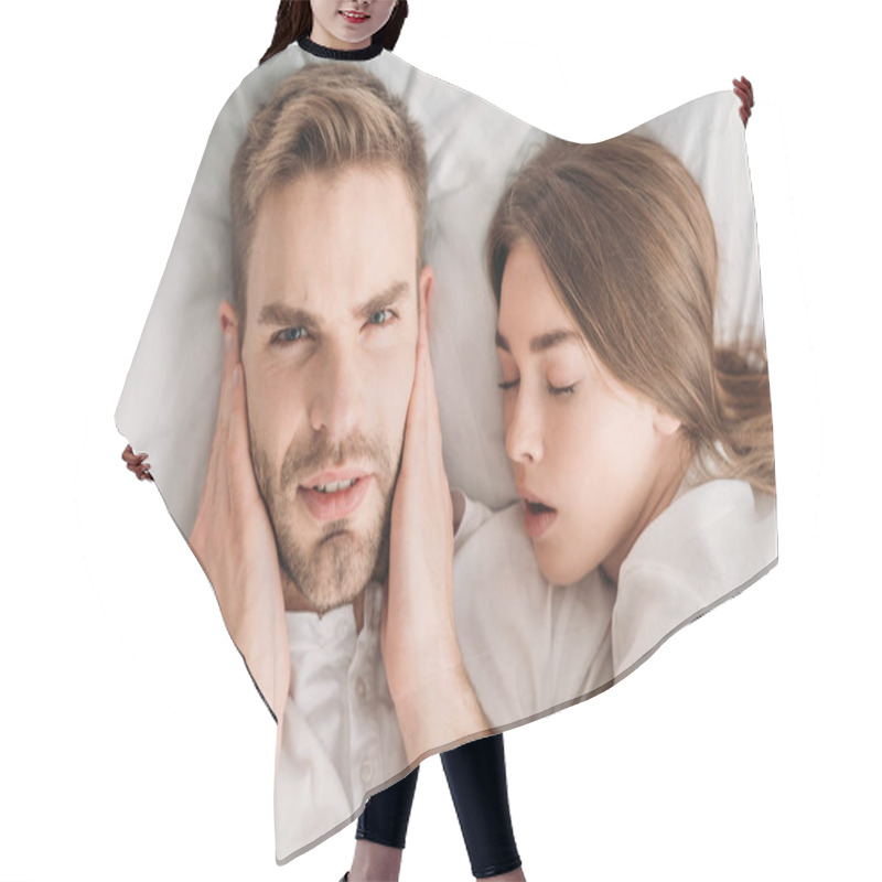 Personality  Displeased Man Plugging Ears With Hands And Looking At Camera While Lying In Bed Near Snoring Wife Hair Cutting Cape