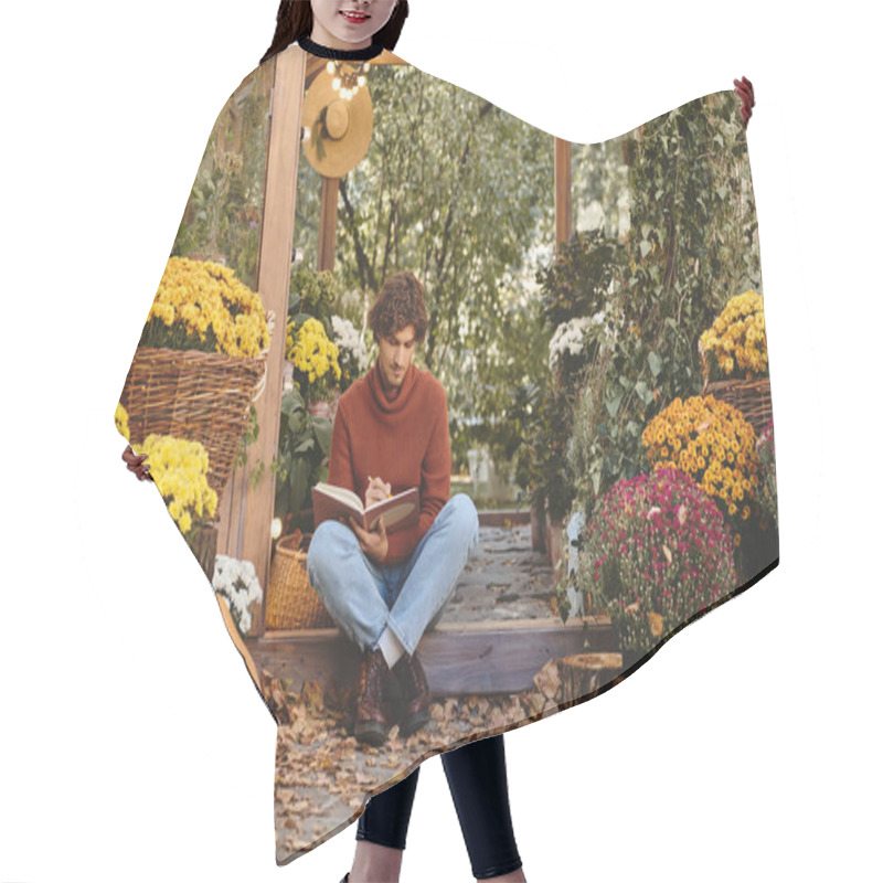 Personality  In A Serene Garden Filled With Blooming Flowers, A Young And Handsome Man Sits On The Ground, Immersed In Writing In A Notebook. Hair Cutting Cape