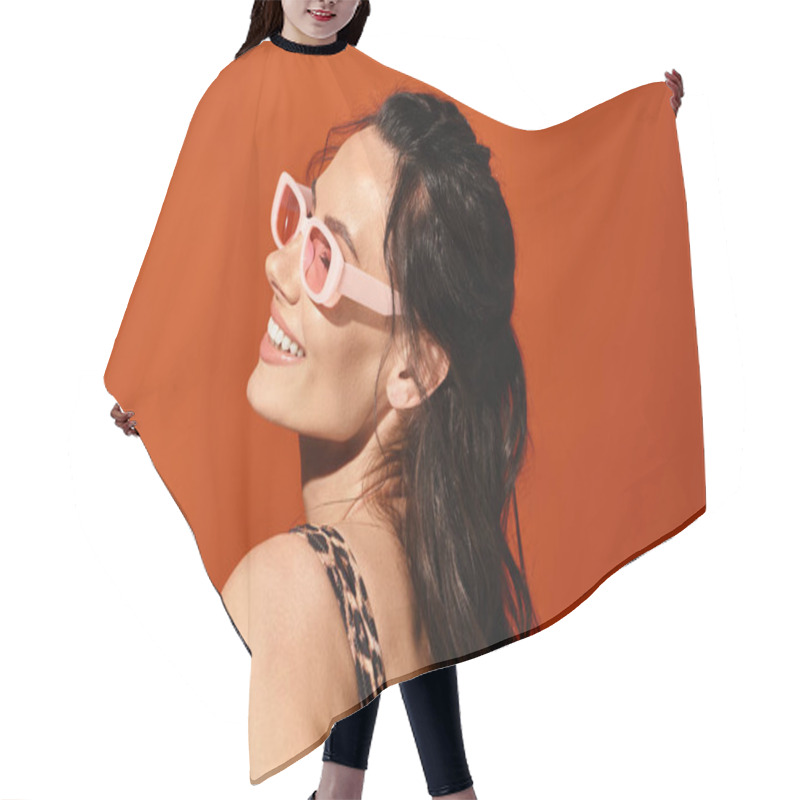 Personality  A Fashionable Woman Exudes Confidence In Pink Sunglasses And A Leopard Print Dress Against A Vibrant Orange Backdrop. Hair Cutting Cape