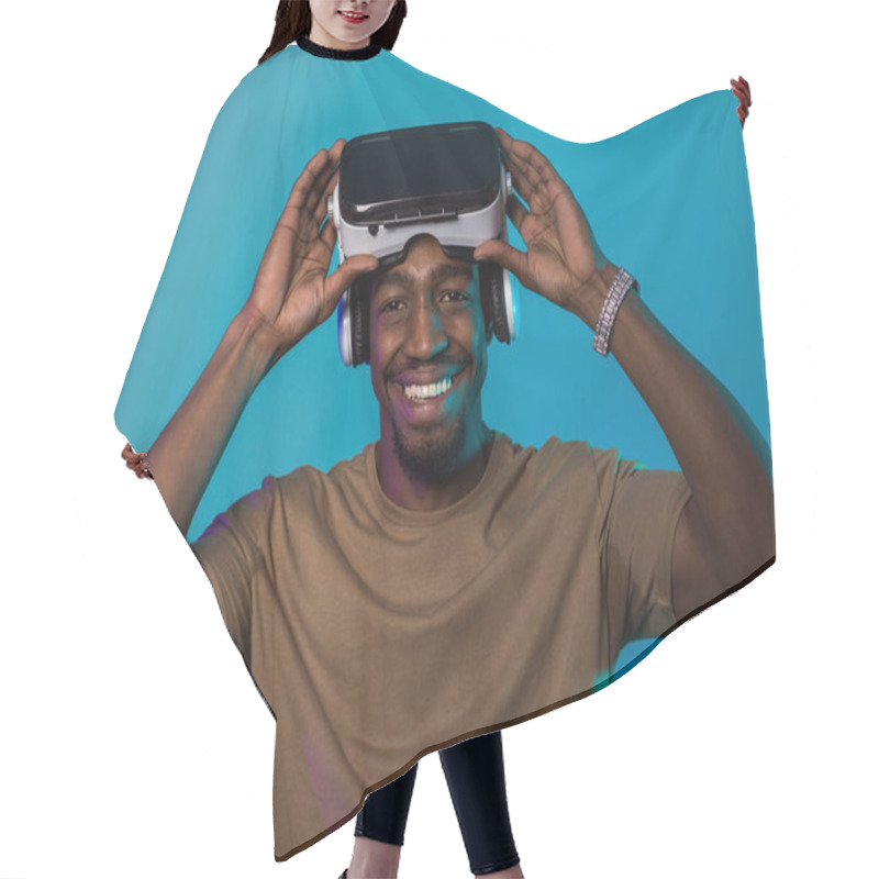 Personality  In A Futuristic Visual, An African American Man Stands Isolated Against A Striking Blue Backdrop, Adorned With VR Glasses That Transport Him Into A Cutting-edge Virtual Reality Experience, Merging Hair Cutting Cape