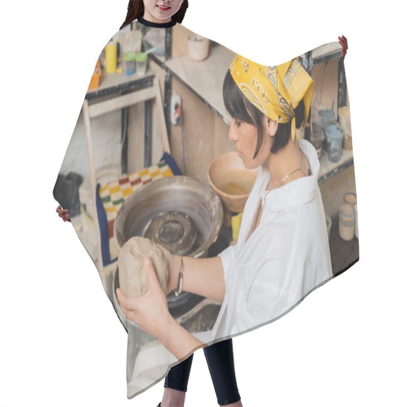 Personality  High Angle View Of Young Brunette Asian Artisan In Headscarf Holding Clay And Working Near Pottery Wheel And At Background In Studio, Craftsmanship In Pottery Making Hair Cutting Cape