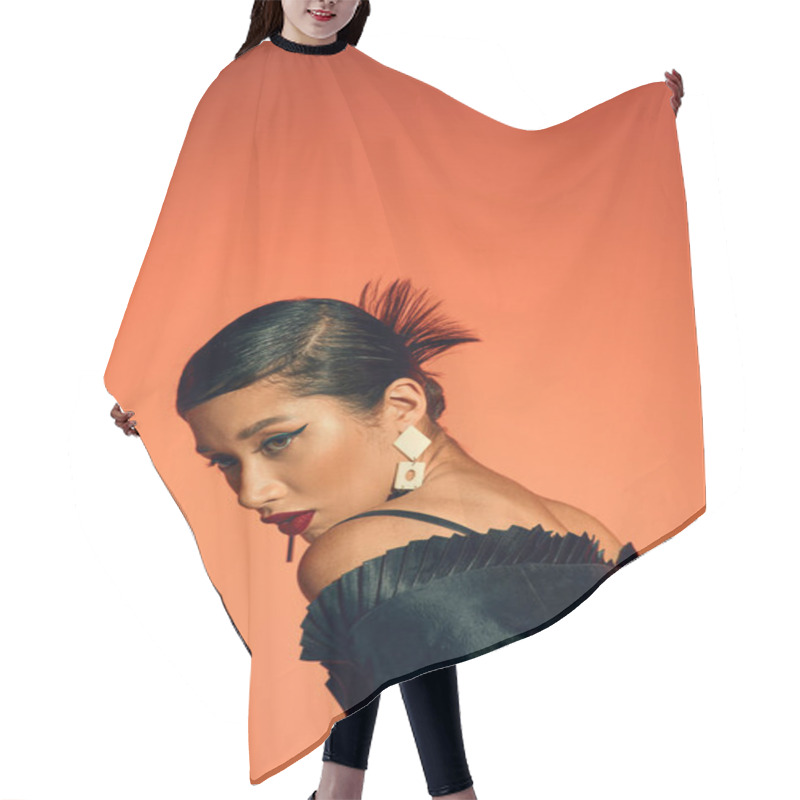 Personality  Portrait Of Glamour Asian Woman With Bold Makeup And Brunette Hair, Wearing Trendy Earrings And Black Elegant Dress While Posing On Orange Background, Generation Z, Spring Fashion Photography Hair Cutting Cape