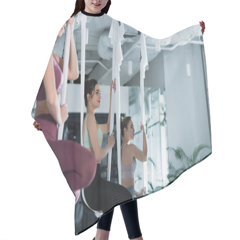 Personality  Three Young Women Practicing Lotus Pose In Aerial Yoga Hammocks, Blurred Foreground Hair Cutting Cape