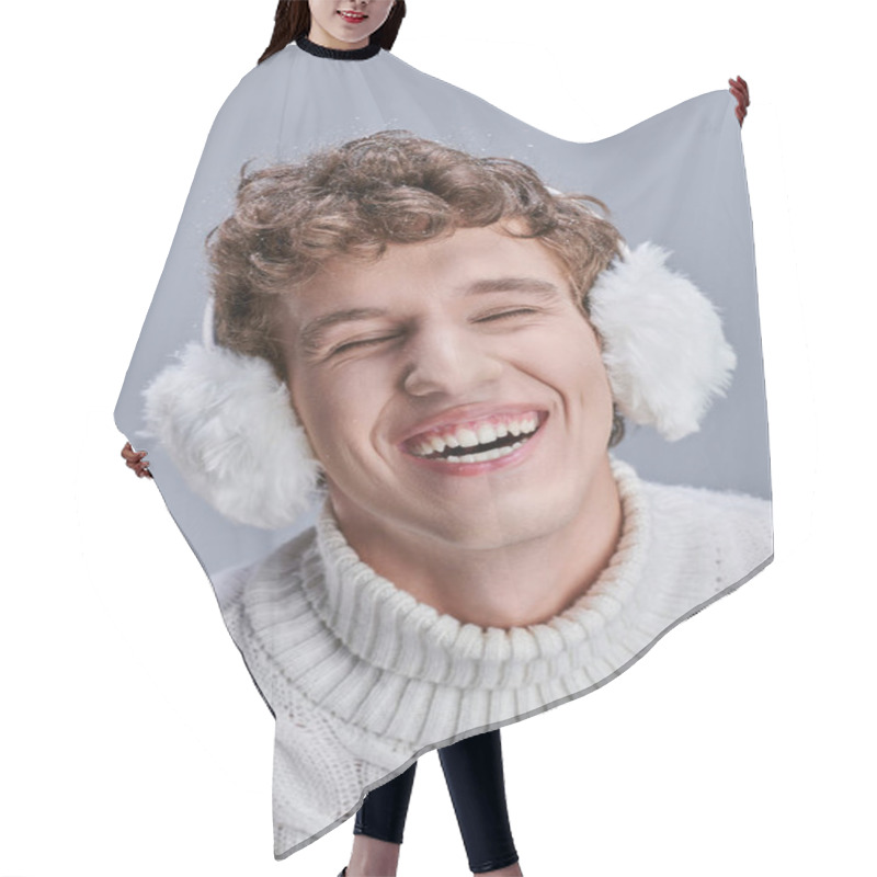 Personality  Excited Man In Earmuffs And White Sweater Laughing With Closed Eyes On Grey, Happy Stylish Winter Hair Cutting Cape