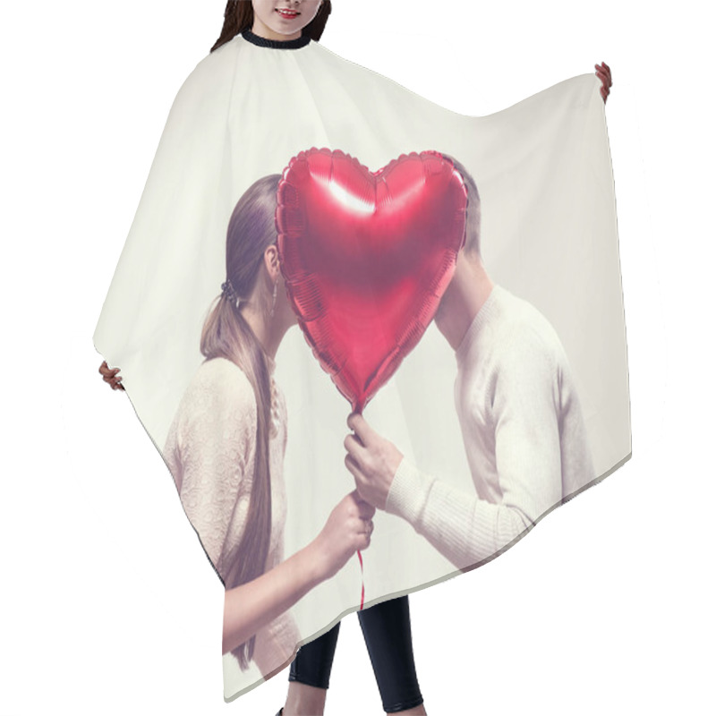 Personality  Valentine's Day. Happy Joyful Couple Holding Heart Shaped Air Balloon And Kissing. Love Hair Cutting Cape