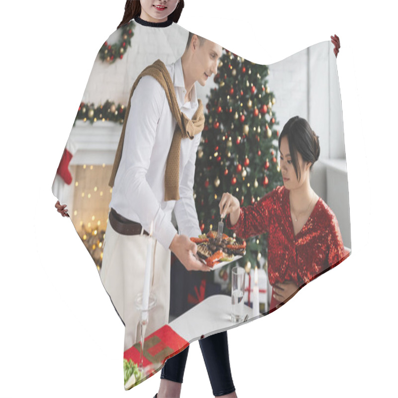 Personality  Man Holding Grilled Vegetables Near Pregnant And Elegant Asian Woman During Romantic Supper Near Christmas Tree  Hair Cutting Cape