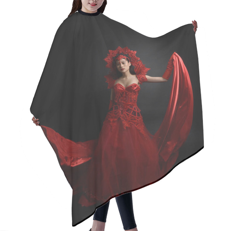 Personality  Dramatic Portrait Of Beautiful Young Asian Woman Wearing Red Corset, Long Opera Gloves And Ornate Gothic Queen Crown. Graceful Posing Isolated On A Dark Studio Background. Hair Cutting Cape