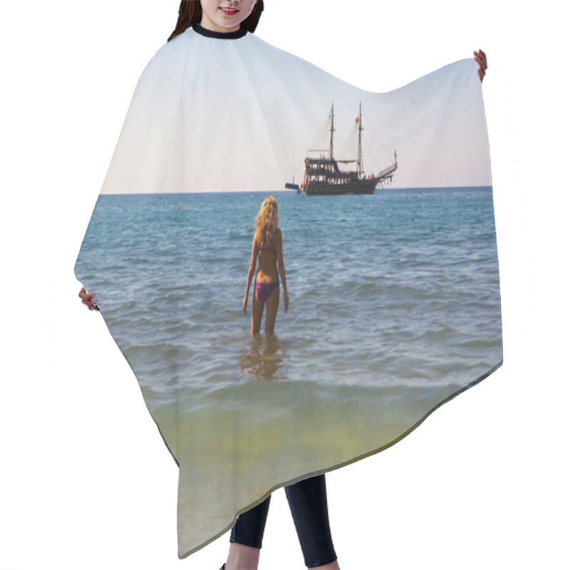 Personality  The Girl Is Standing In The Sea And Looking At The Medieval Ship. Turkey. Hair Cutting Cape