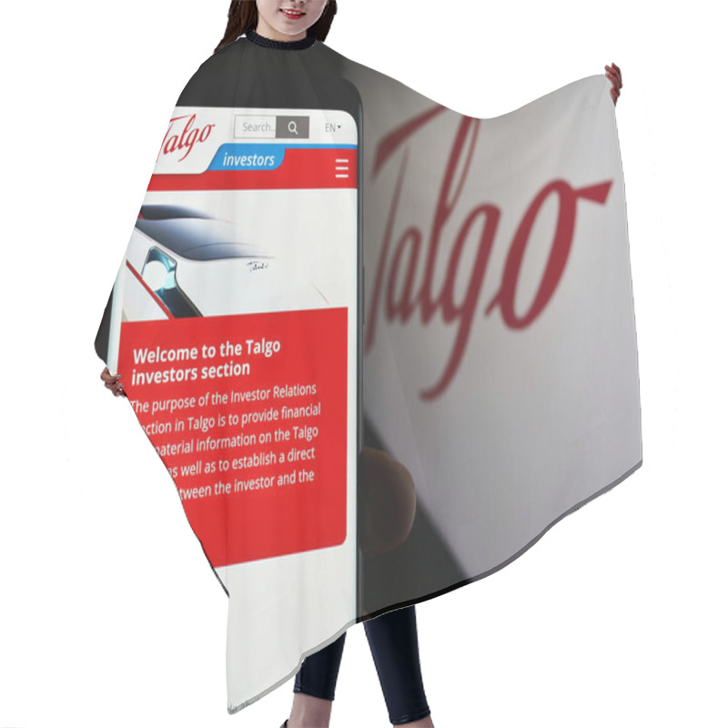 Personality  Stuttgart, Germany - 04-08-2024: Person Holding Mobile Phone With Web Page Of Spanish Train Manufacturing Company Talgo S.A. In Front Of Logo. Focus On Center Of Phone Display. Hair Cutting Cape