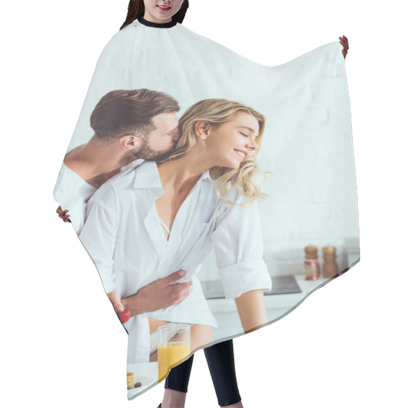 Personality  Young Man Hugging Happy Girlfriend While Standing Near Kitchen Table With Served Breakfast Hair Cutting Cape