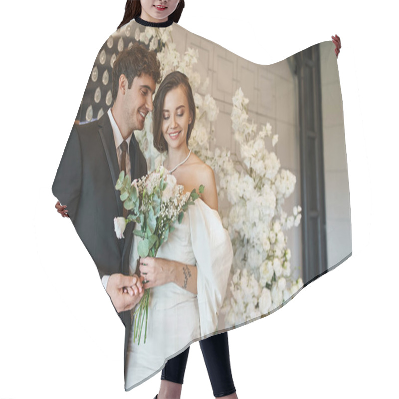 Personality  Happy Groom Holding Hand Of Charming Bride With Bridal Bouquet Near Floral Decor In Event Hall Hair Cutting Cape