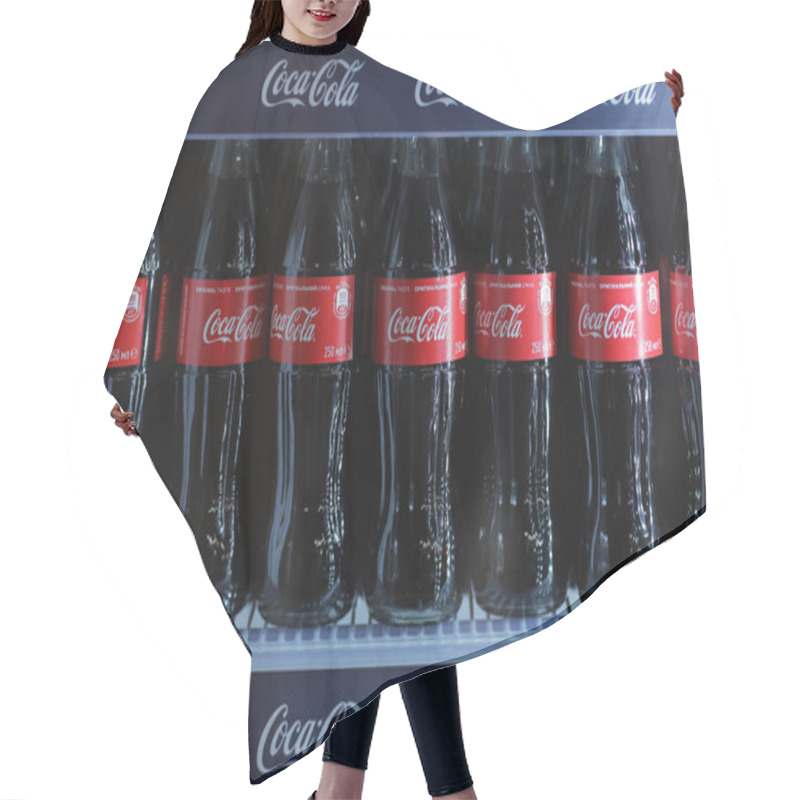 Personality  Rivne, Ukraine - 18 February 2020: Bottles Of Coca Cola Drink When In A Mini Fridge. Hair Cutting Cape