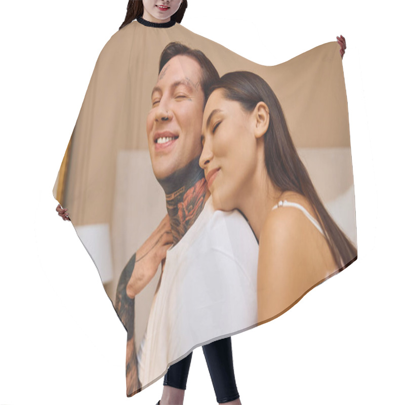 Personality  Young Couple Smiles Joyfully While Embracing Each Other In A Warm Indoor Atmosphere. Hair Cutting Cape