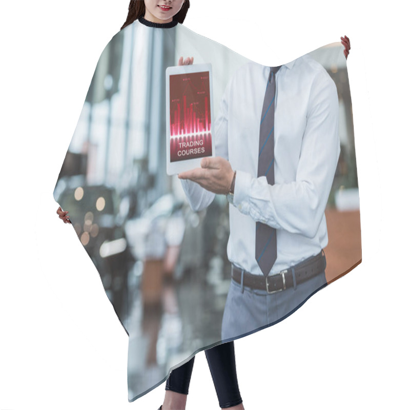 Personality  Partial View Of Dealership Salon Seller In Formal Wear Showing Tablet With Trading Courses Diagram In Hands  Hair Cutting Cape