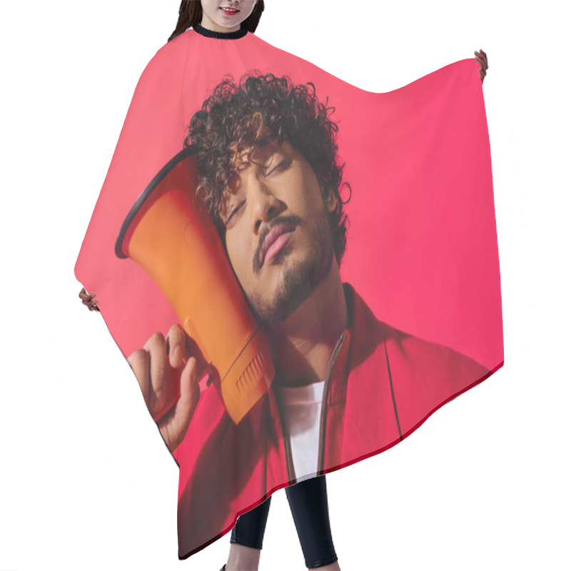 Personality  Vibrant Young Indian Man Holding Red And Orange Megaphone. Hair Cutting Cape