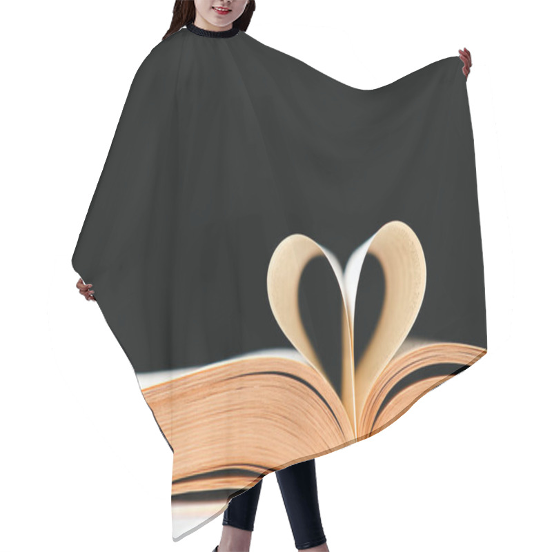 Personality  The Pages Of The Book Are Folded In The Shape Of A Heart On A Black Background, Place For Text. Hair Cutting Cape