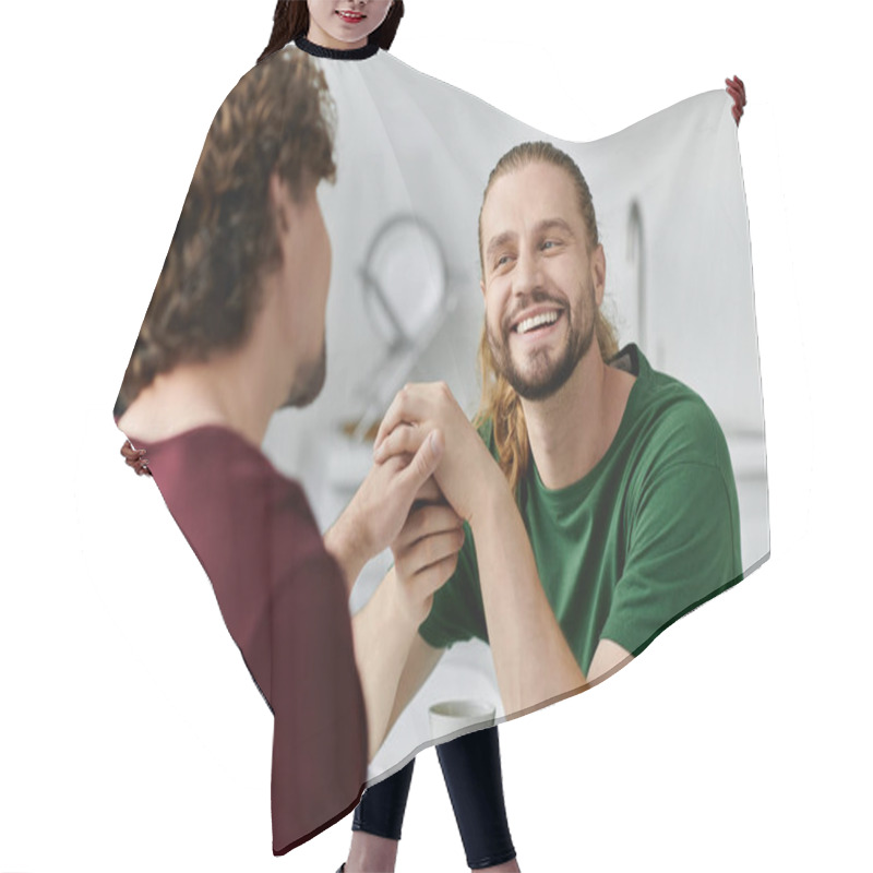 Personality  Two Men Enjoy A Warm Moment Together, Holding Hands And Laughing In Their Cozy Kitchen. Hair Cutting Cape