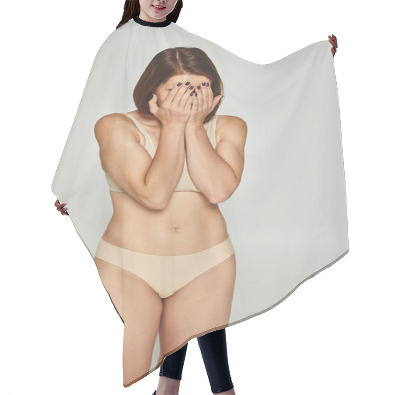 Personality  Embarrassed Young Woman In Beige Underwear Covering Face With Hands On Grey Background, Body Shaming Hair Cutting Cape