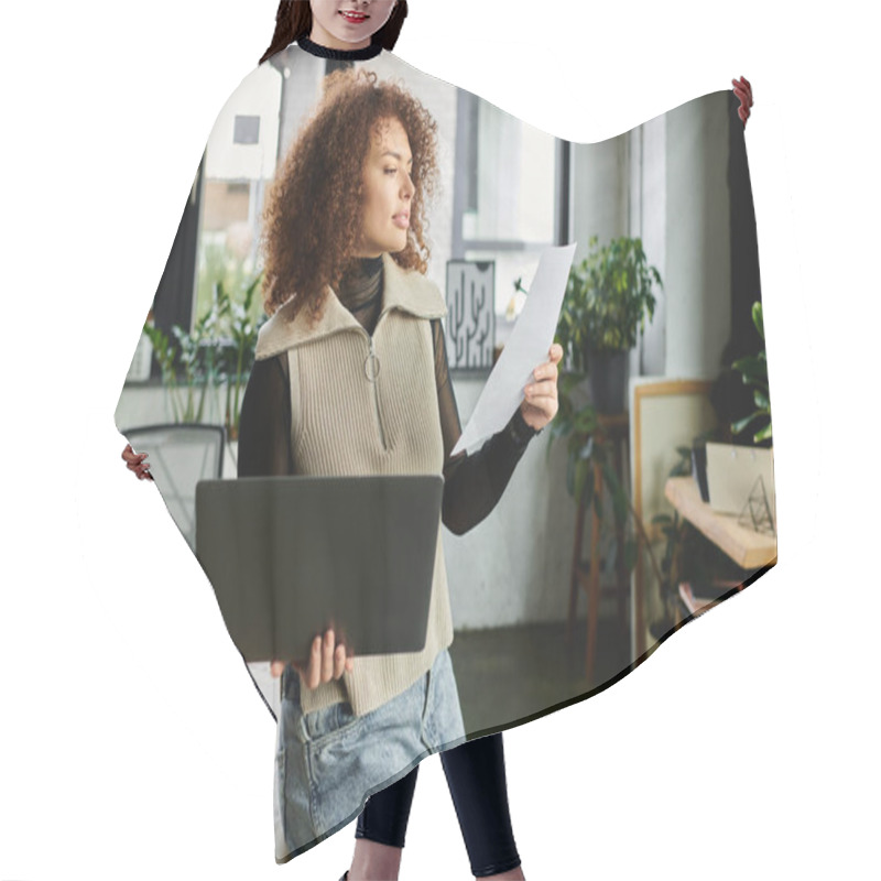 Personality  A Woman In A Cozy Workspace Studies Important Papers While Holding A Laptop And Looking Engaged. Hair Cutting Cape