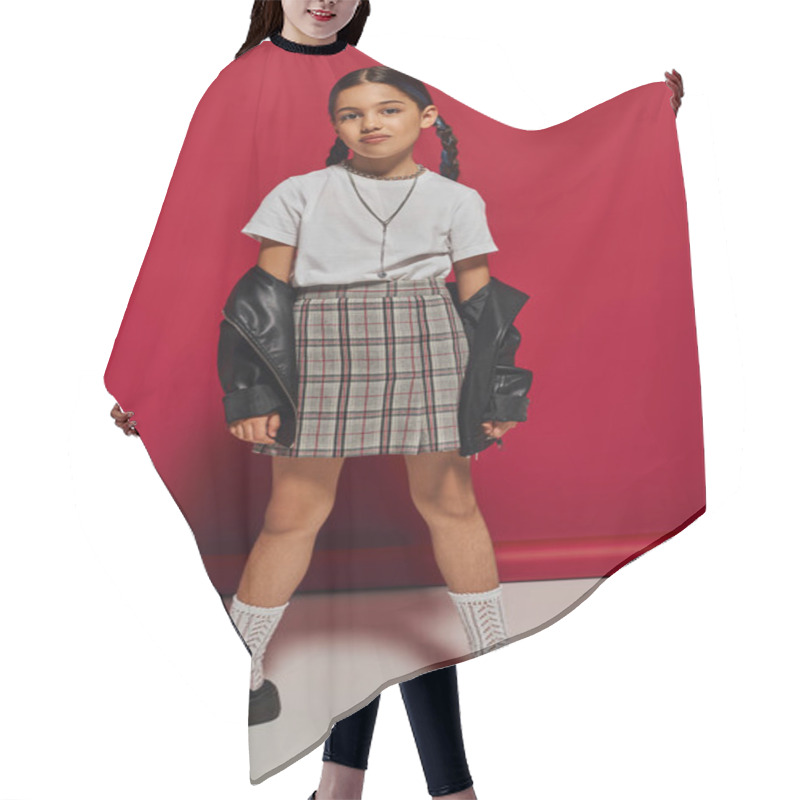 Personality  Full Length Of Trendy Brunette Preteen Girl With Hairstyle Posing In Plaid Skirt And Leather Jacket While Looking At Camera And Standing On Red Background, Stylish Preteen Outfit Concept Hair Cutting Cape