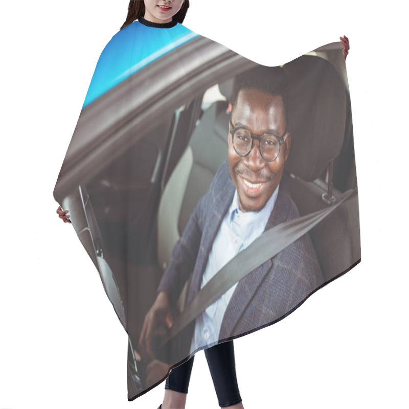 Personality  Young Happy Man Fastening His Seatbelt Before A Trip By Car And Looking At Camera. Portrait Of Young Hispanic Man Sitting In Driving Seat Of Car, Fastening Safety Belt And Making En Eye Contact Hair Cutting Cape