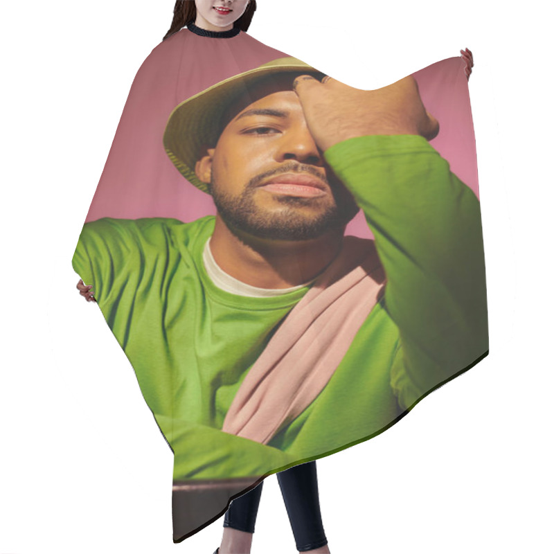 Personality  Handsome Young Man With Beard In Green Hat With Palm On His Face Looking At Camera, Fashion Concept Hair Cutting Cape