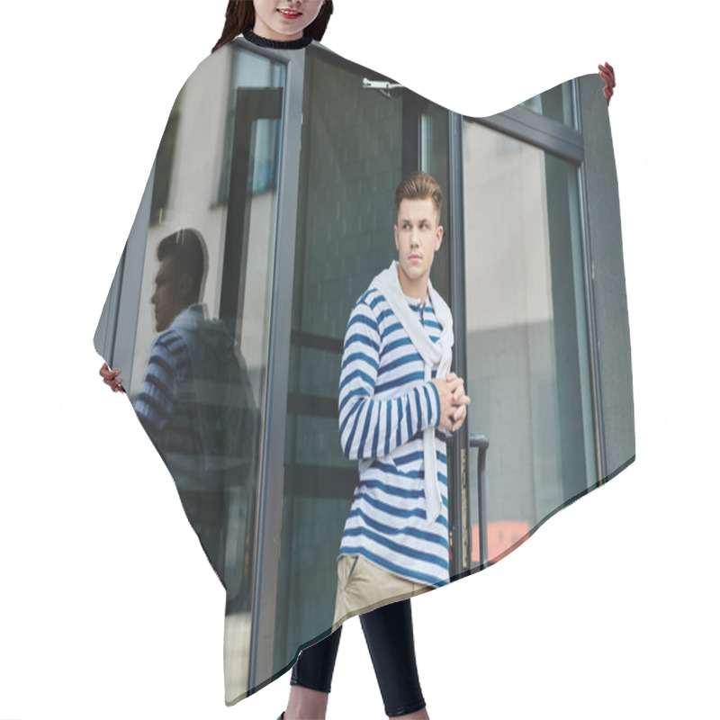 Personality  A Young Man Wearing A Striped Sweater And Khakis Gazes Pensively Outside A Glass Door. Hair Cutting Cape