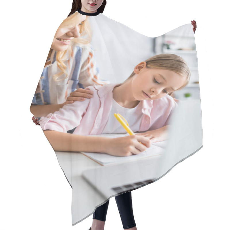 Personality  Selective Focus Of Smiling Woman Looking At Kid Writing On Notebook Near Laptop  Hair Cutting Cape