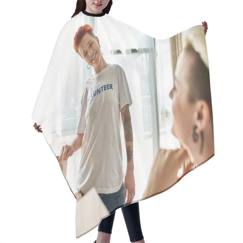 Personality  A Woman In A Volunteer T-shirt Smiles Next To A Box, Showing Her Support For A Charitable Cause. Hair Cutting Cape