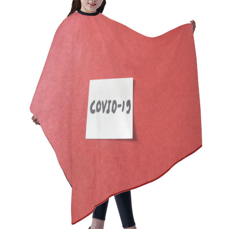 Personality  Note COVID-19 /coronavirus On White Paper On The Red Background. Economy And Financial Markets Affected By Corona Virus. Flat Lay, Space For Text. Hair Cutting Cape