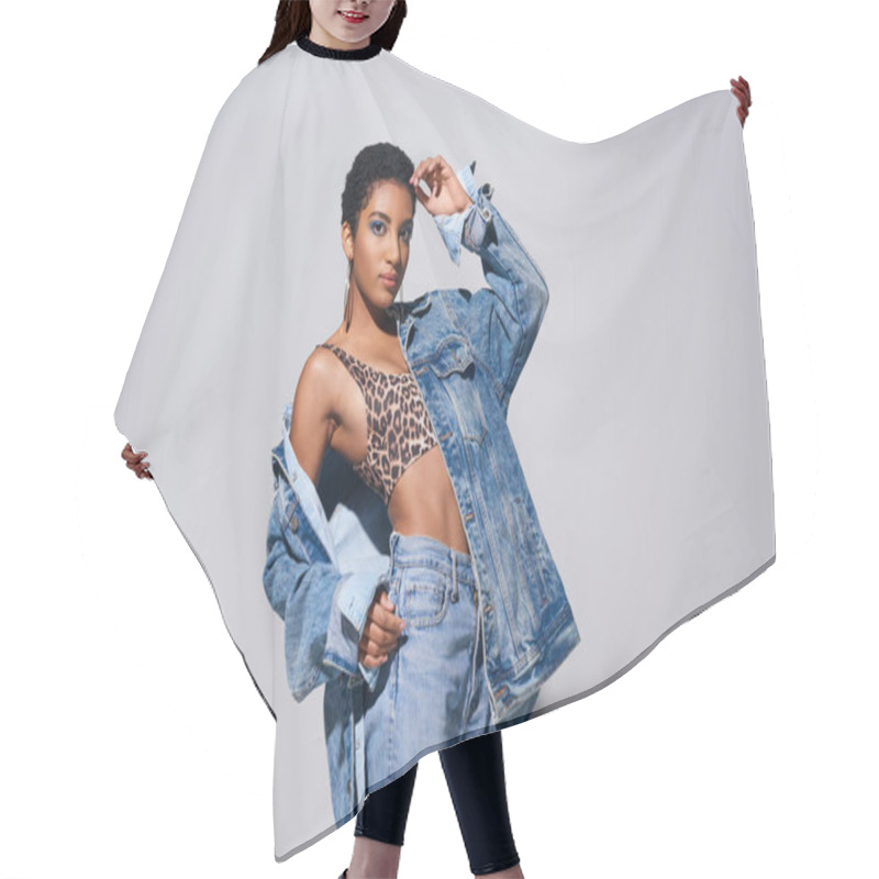 Personality  Confident Young African American Woman With Short Hair Posing In Top With Animal Print, Jeans And Denim Jacket While Standing On Grey Background, Denim Fashion Concept Hair Cutting Cape