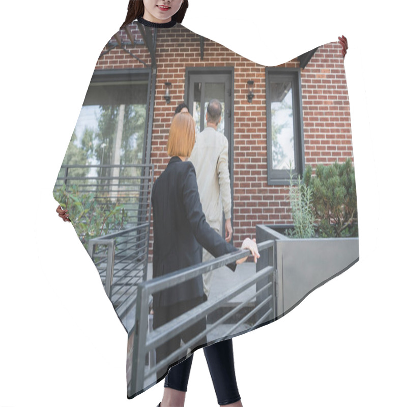 Personality  Back View Of Redhead Realtor Walking Behind Couple While Entering Modern House Hair Cutting Cape