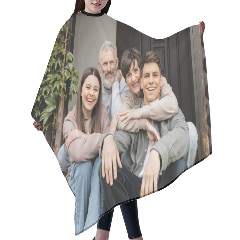 Personality  Positive Middle Aged Parents Hugging Children And Looking At Camera While Sitting On Porch Of House During Parents Day Celebration In June, Family Traditions And Celebrations Concept Hair Cutting Cape