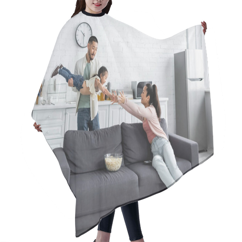 Personality  Asian Father Holding Daughter Near Wife Sitting On Couch Hair Cutting Cape