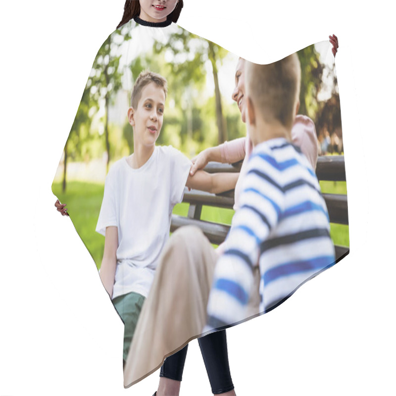 Personality  Happy Mother Is Sitting With Her Sons On Bench In Park. They Are Talking And Enjoying Their Time Together. Hair Cutting Cape