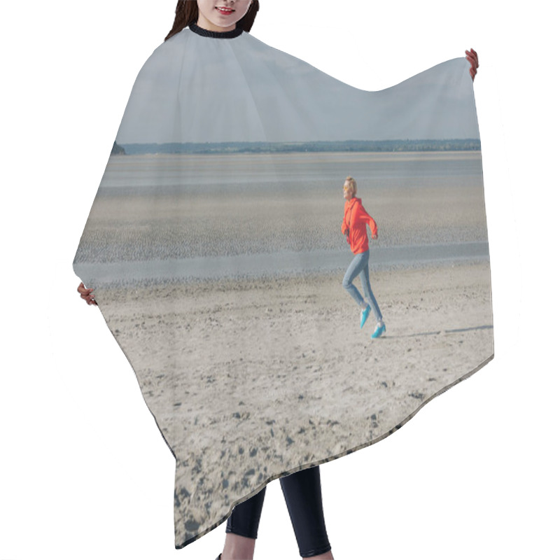 Personality  Stylish Young Woman Running On Sandy Beach, Saint Michaels Mount, France Hair Cutting Cape