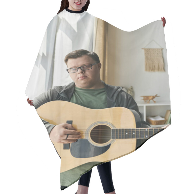 Personality  A Young Man With Down Syndrome Plays Guitar, Embracing His Love For Music Indoors. Hair Cutting Cape