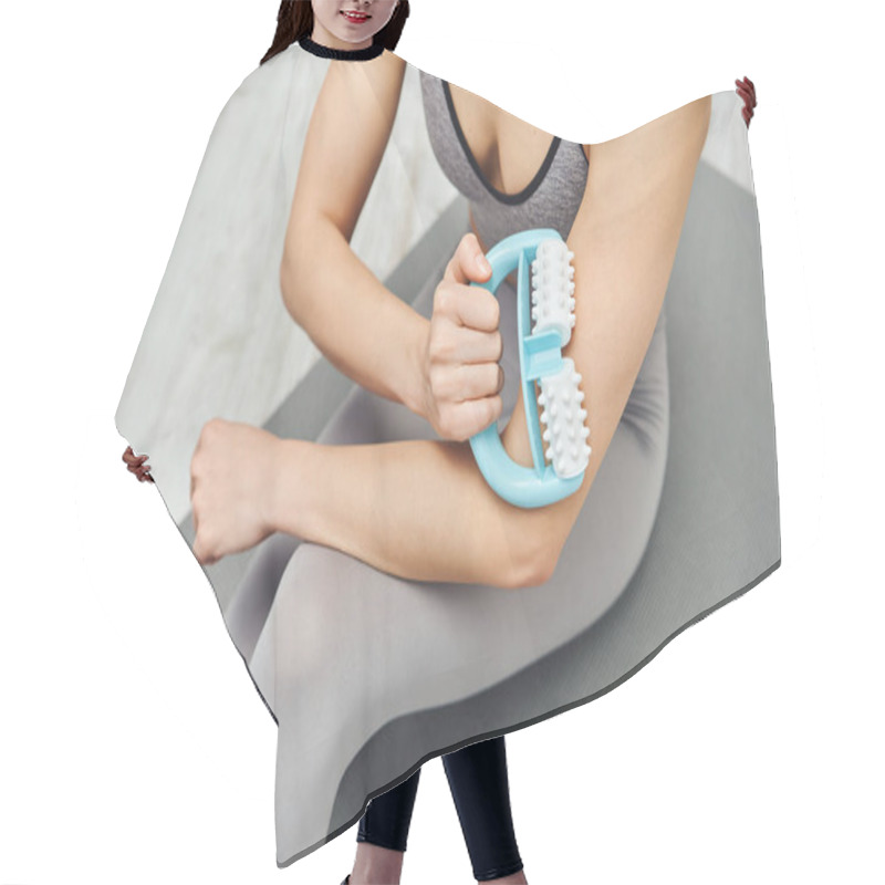 Personality  Top View Of Young Woman In Sportswear Massaging Muscle On Arm With Handled Massager And Sitting On Fitness Mat At Home, Therapeutic Tool For Massage And Holistic Wellness Practices Concept Hair Cutting Cape