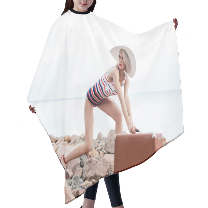 Personality  Attractive Stylish Tourist In Swimsuit Posing With Retro Travel Bag On Rocky Beach Hair Cutting Cape