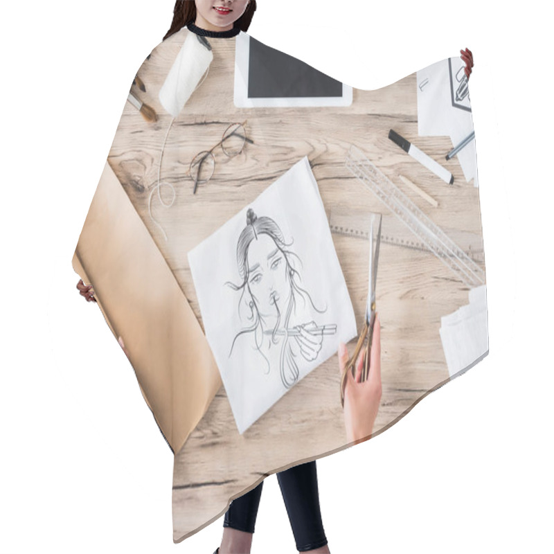 Personality  Cropped Image Of Female Fashion Designer With Scissors Sitting At Table With Paintings And Digital Tablet  Hair Cutting Cape