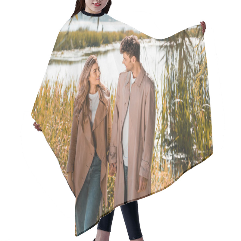 Personality  Pleased Woman And Man In Trench Coats Holding Hands Near Lake In Autumnal Park Hair Cutting Cape