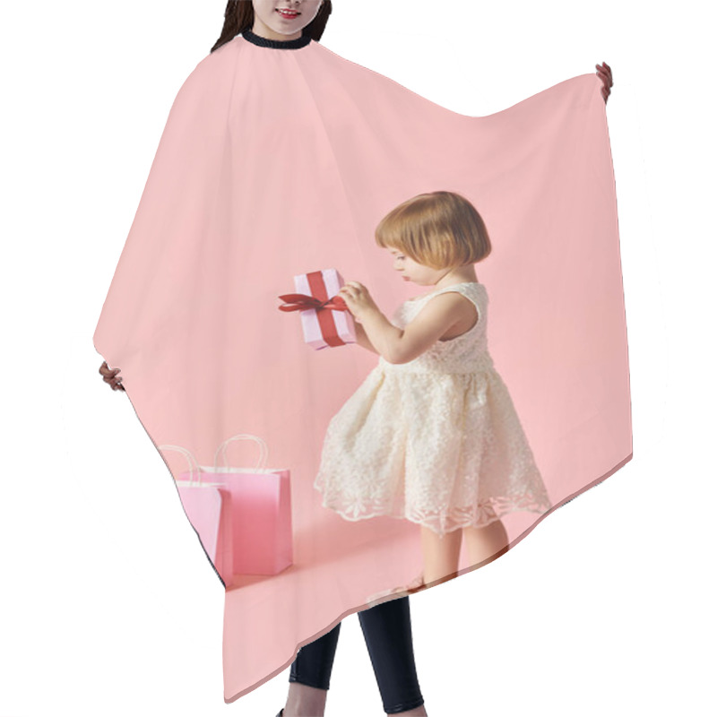 Personality  Little Girl In White Dress Joyfully Holds A Pink Gift Box. Hair Cutting Cape