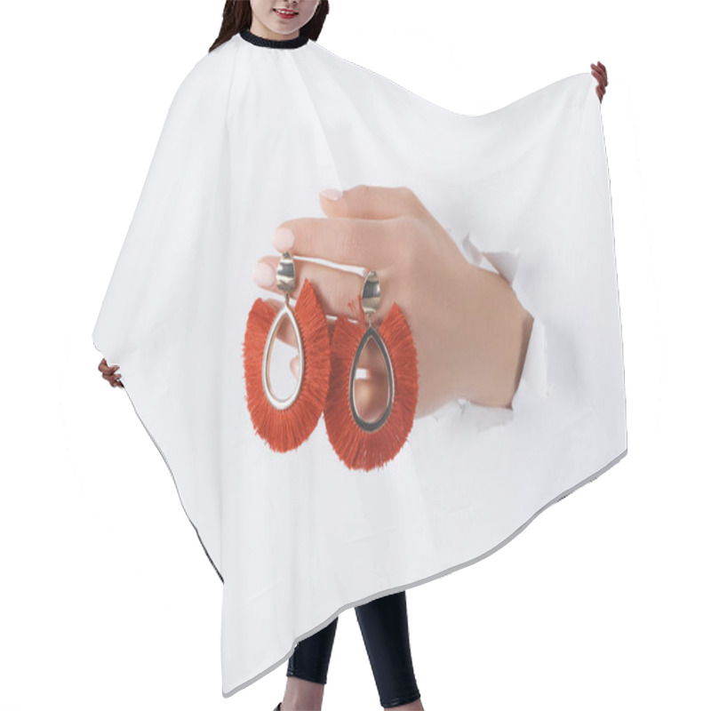 Personality  Cropped Image Of Woman Holding Hand With Beautiful Luxury Red Earrings Through White Paper Hair Cutting Cape