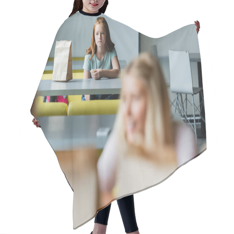 Personality  Depressed Girl With Sandwich Sitting Alone In School Eatery Near Classmates On Blurred Foreground Hair Cutting Cape