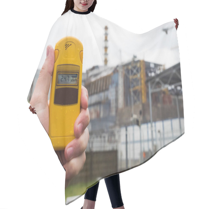 Personality  Radiometer In Hand With Fourth Reactor On The Background Hair Cutting Cape