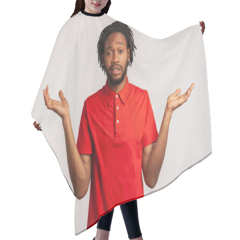 Personality  I Don't Know! Handsome Bearded Man With Dreadlocks Wearing Red Casual Style T-shirt, Standing With Raised Arms And Looking At Camera With Answer. Indoor Studio Shot Isolated On Gray Background. Hair Cutting Cape