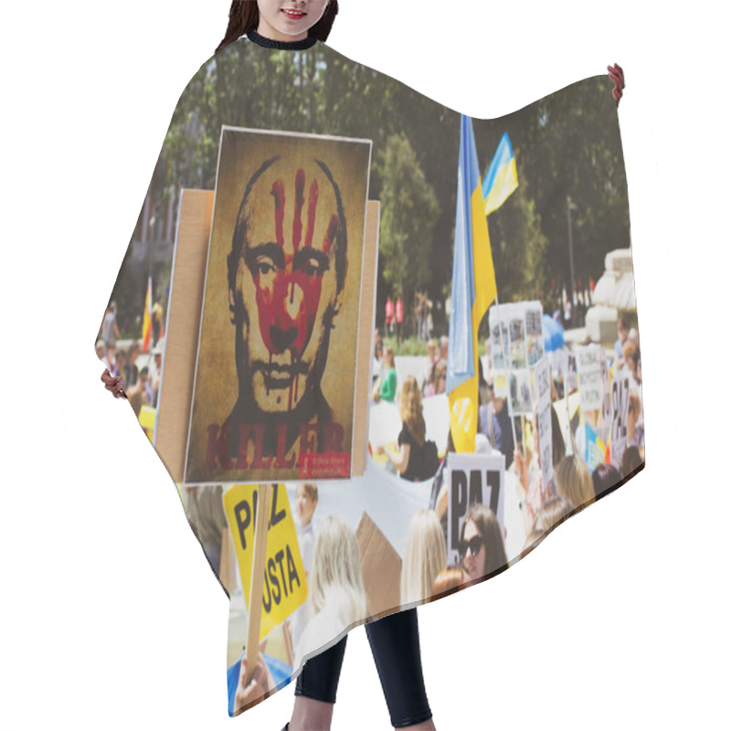 Personality  Madrid, Spain. May 8, 2022. People At Rally In Support Of Ukrainians Affected By Russia. Ukrainian Flags. Placard Of A Murder Putin Russian President. Hair Cutting Cape